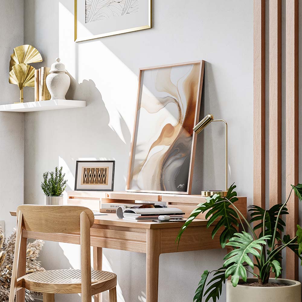 A brown, white, and black abstract painting with fluid, organic shapes on a white wall, above a wooden table with a plant and a lamp.