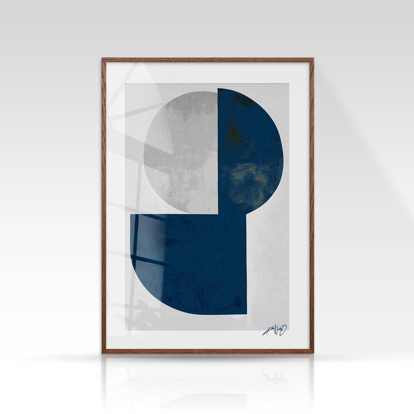Moderne plakat i blå og grå toner med geometriske former, indrammet i egetræ. Design af Kali Nuevo.